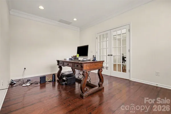 a view of a workspace with furniture and wooden floor