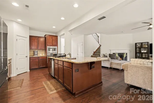 a kitchen with granite countertop a sink counter top space appliances and cabinets