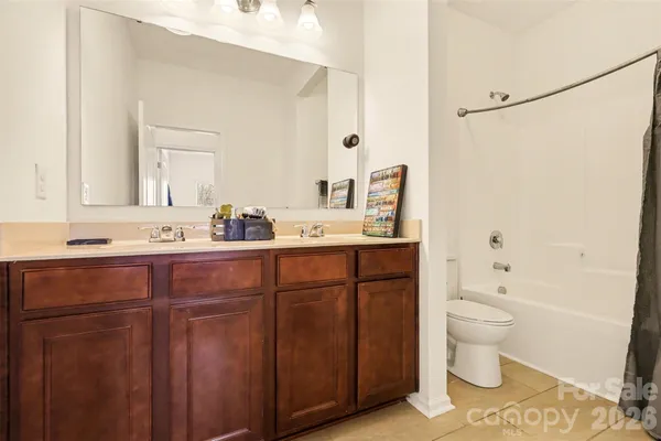 a bathroom with a sink toilet vanity and shower