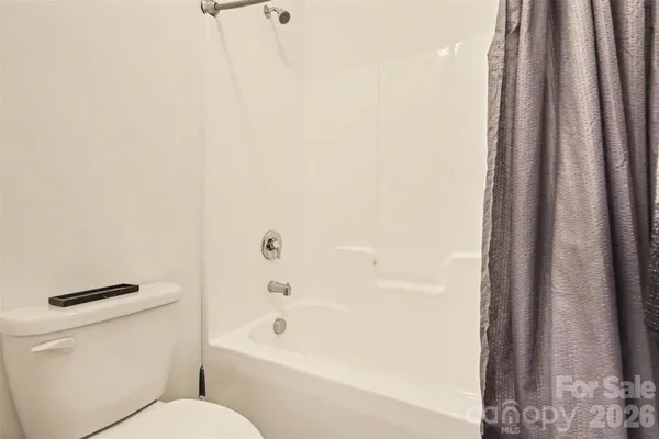 a bathroom with a toilet and a bathtub