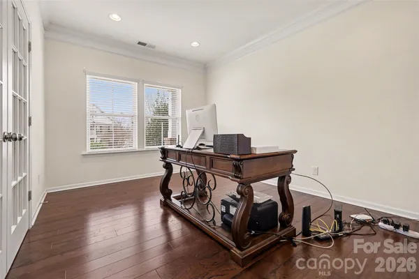 a view of a workspace with furniture and a window