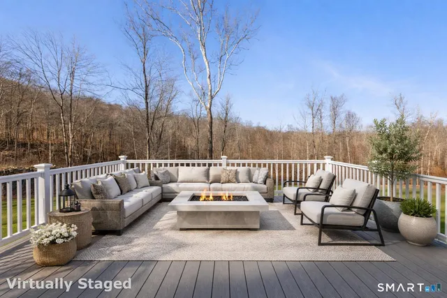 a view of a patio with couches and a potted plant on a table and chairs