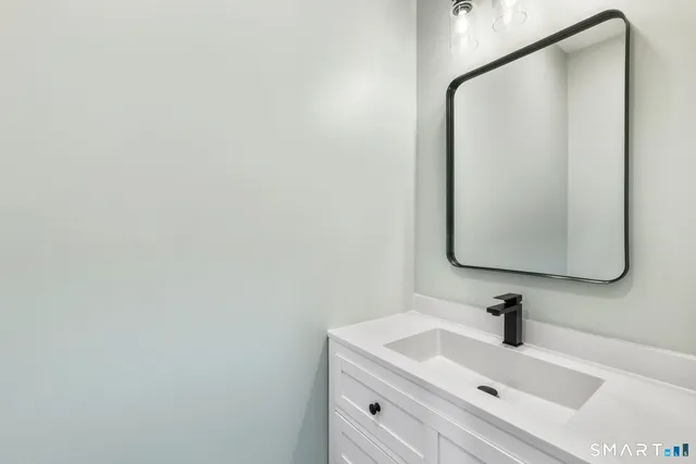 a bathroom with a sink and mirror