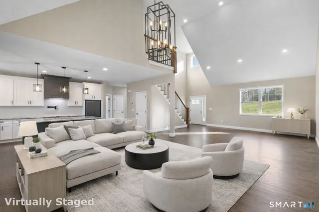 a living room with furniture and a view of kitchen