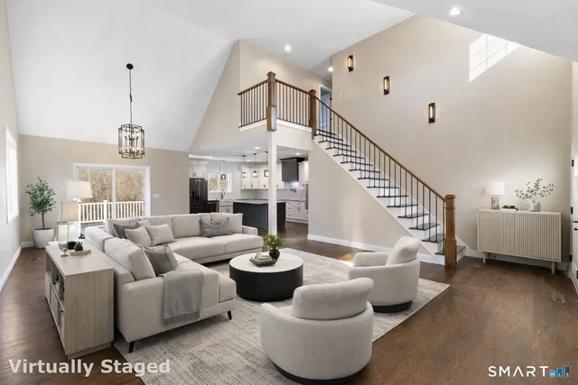 a living room with furniture and a chandelier