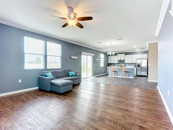 a living room with furniture and a wooden floor