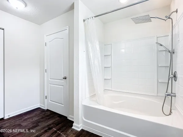 a bathroom with a bathtub and a shower