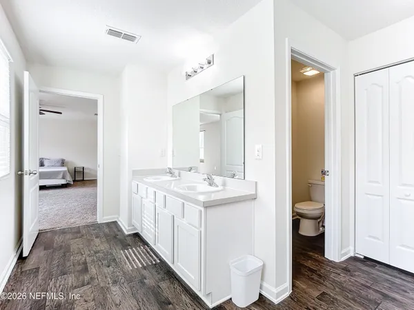 a bathroom with a granite countertop sink toilet and shower view