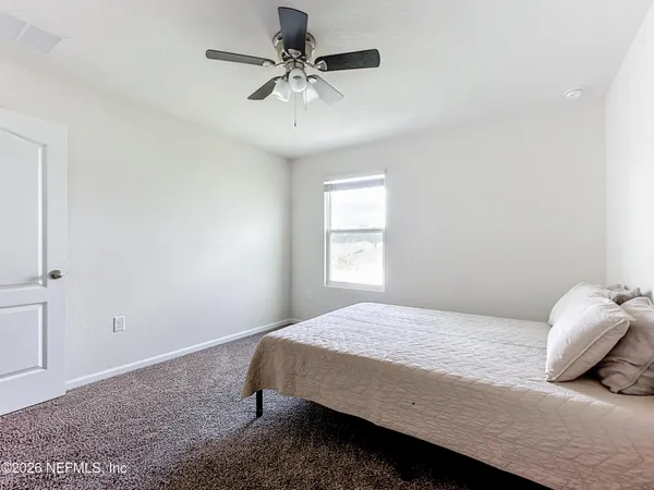 a bedroom with a bed and a window