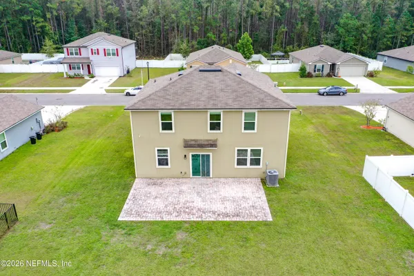 a front view of house with garden and swimming pool