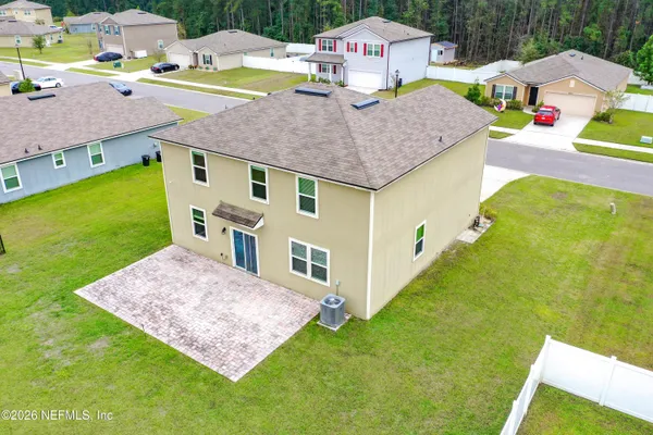 a aerial view of a house with swimming pool patio and backyard