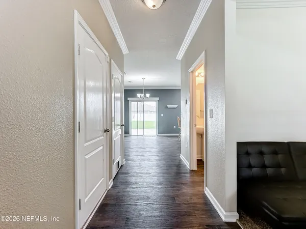 a view of hallway with wooden floor