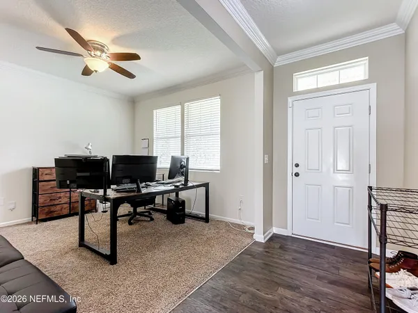 a workspace with wooden floor and a ceiling fan