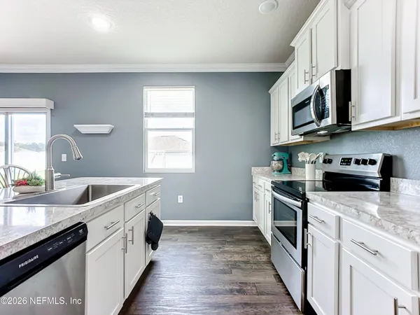 a kitchen with stainless steel appliances granite countertop a sink and stove top oven
