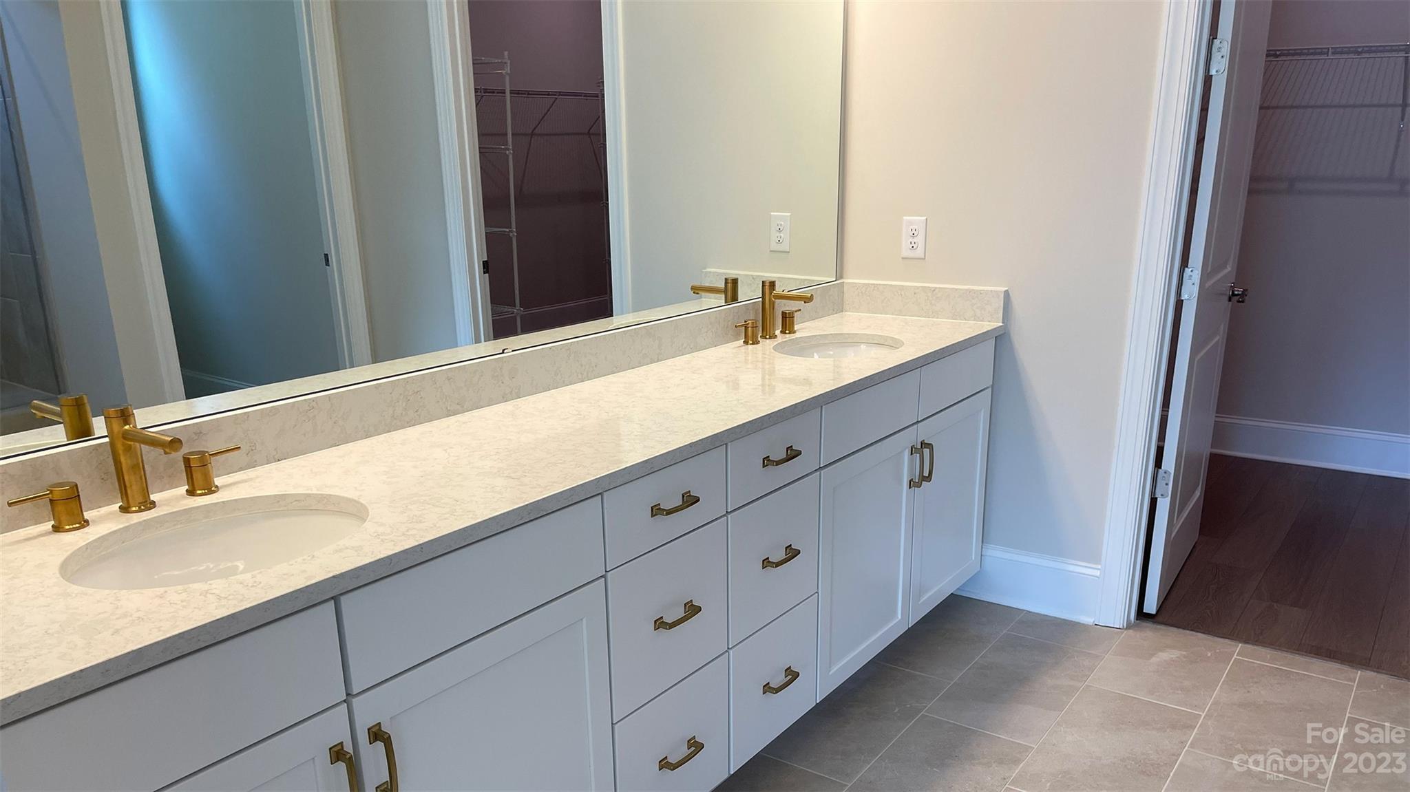 1035 Milestone Court Monroe, NC 28110 - Photo 7 of 9 a bathroom with a double vanity sink and mirror
