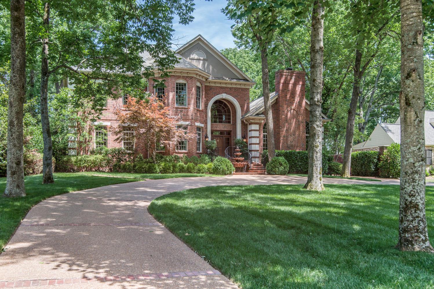 4334 Sneed Road Nashville, TN 37215 - Photo 1 of 30 a front view of a house with a yard and trees