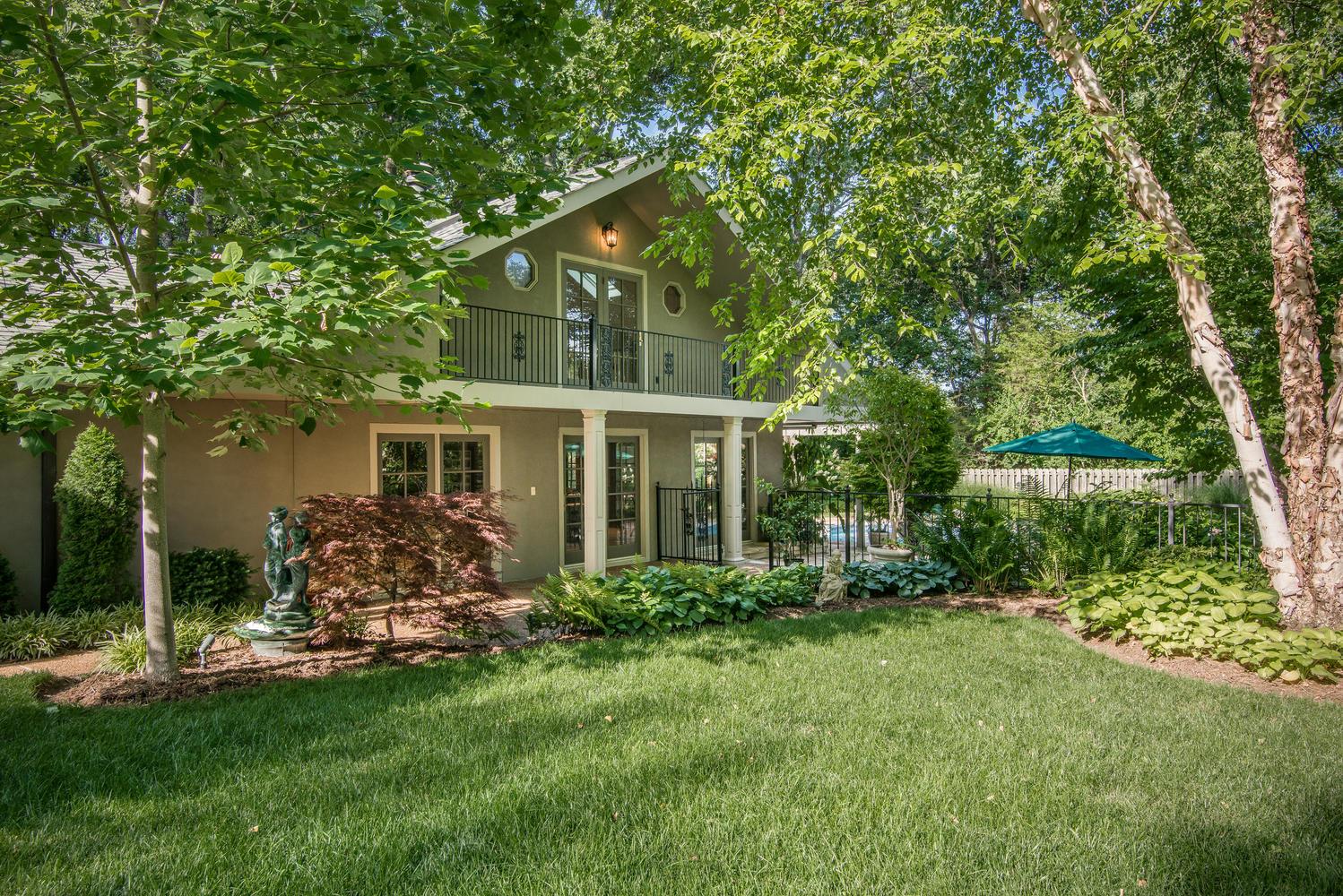 4334 Sneed Road Nashville, TN 37215 - Photo 26 of 30 a backyard of a house with potted plants and large tree
