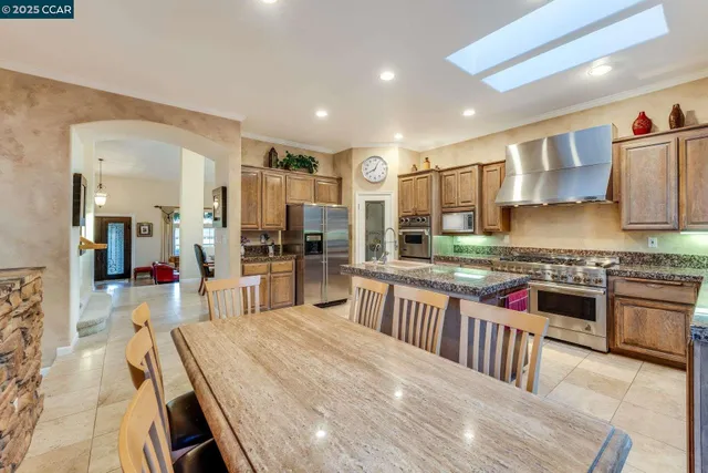 a bathroom with a granite countertop sink and a refrigerator