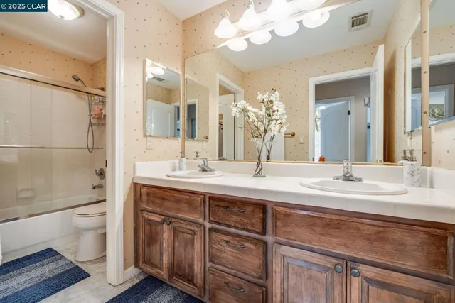 a spacious bedroom with a bed and large windows