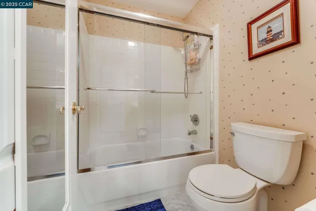 a bedroom with bed and a flat screen tv