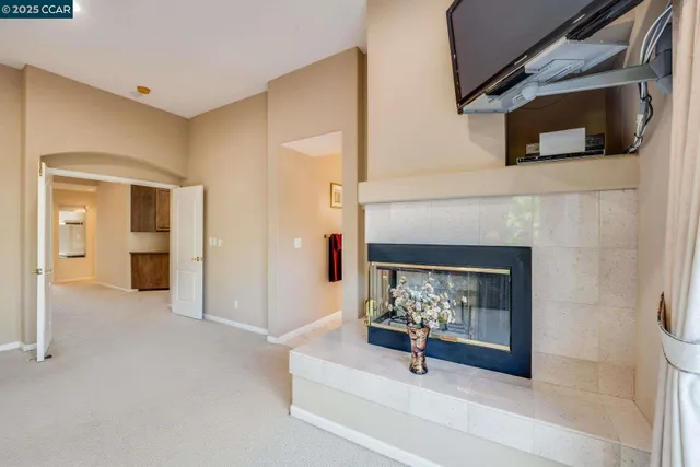 a spacious bathroom with a tub a mirror and a shower