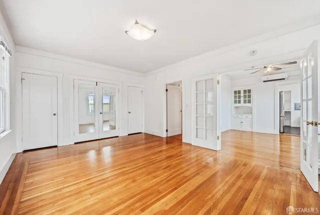 a view of an empty room with wooden floor