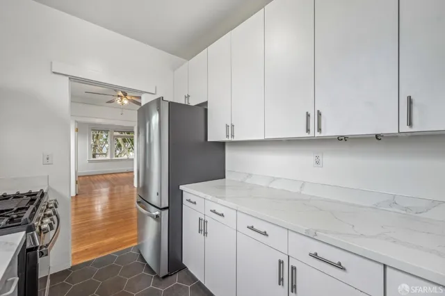 a kitchen with stainless steel appliances granite countertop a refrigerator and a stove