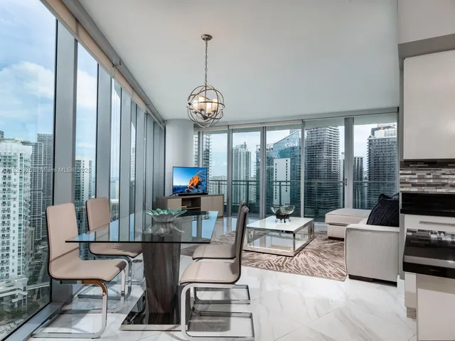 a living room with fireplace furniture and a large window