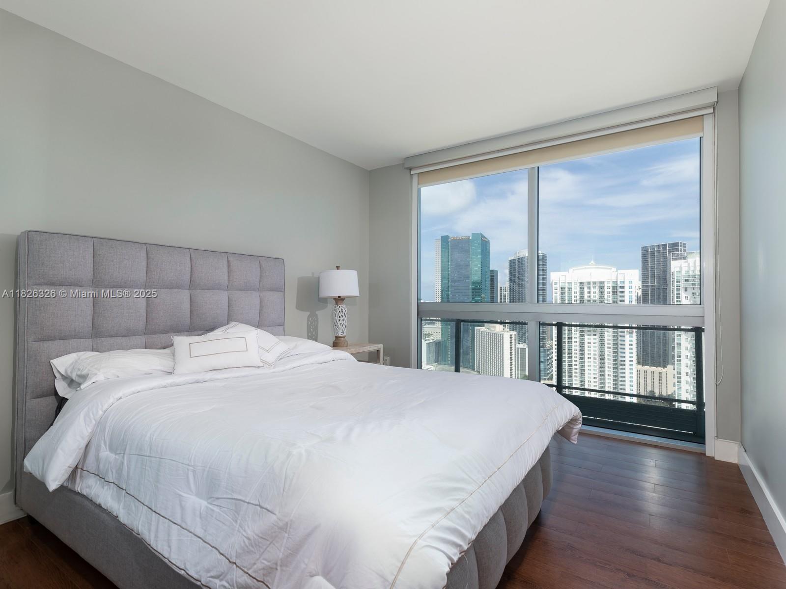 92 Southwest 3rd Street, Unit 3901 Miami, FL 33130 - Photo 5 of 10 a bedroom with a large bed and a large window