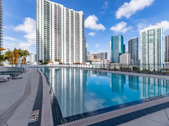 a view of swimming pool with outdoor seating and city view