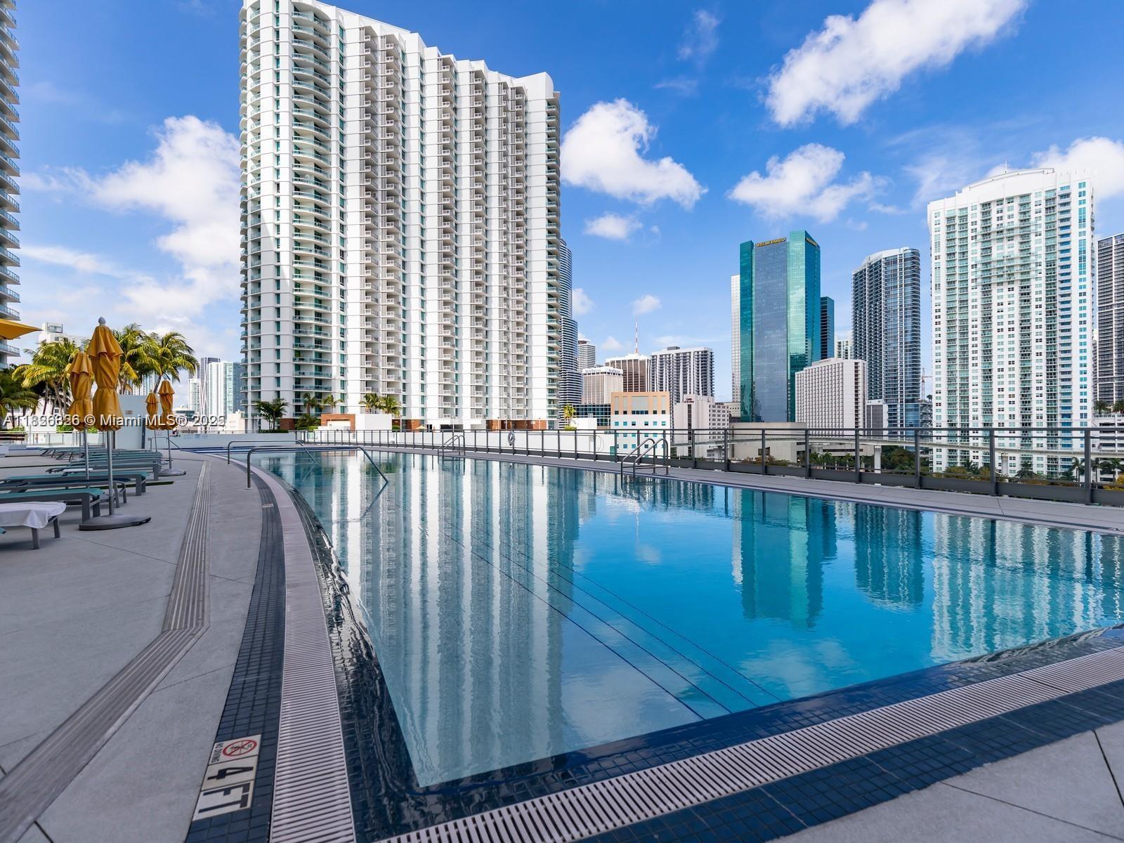 92 Southwest 3rd Street, Unit 3901 Miami, FL 33130 - Photo 9 of 10 a view of swimming pool with outdoor seating and city view