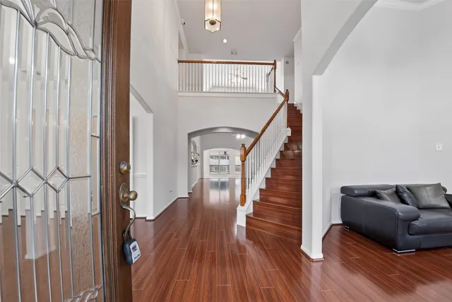 a view of entryway and hall with wooden floor