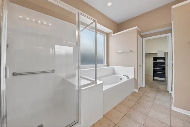 a spacious bathroom with a bathtub and a shower