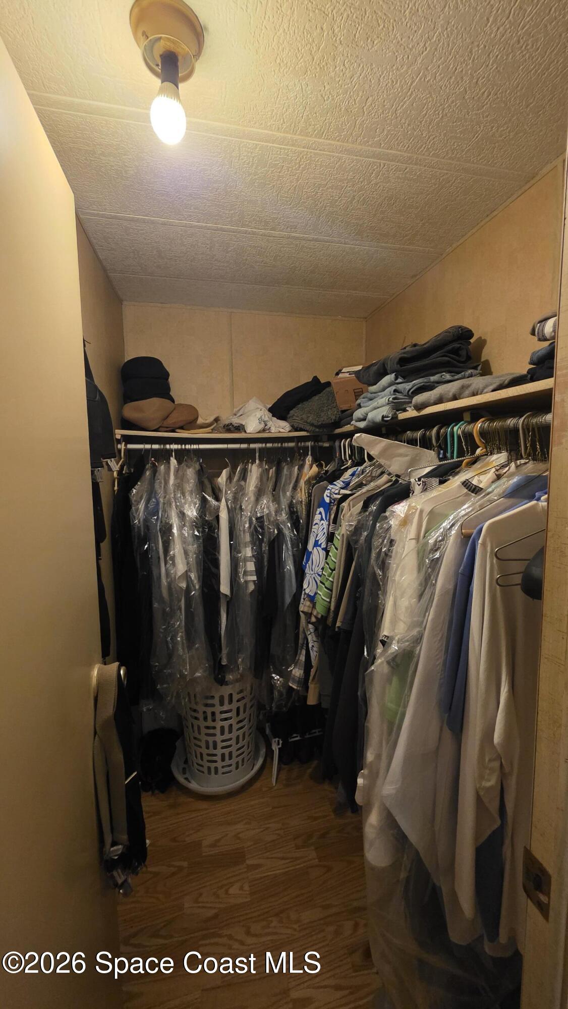 1805 Mango Street Northeast Palm Bay, FL 32905 - Photo 11 of 22 a view of walk in closet with clothes and shoes