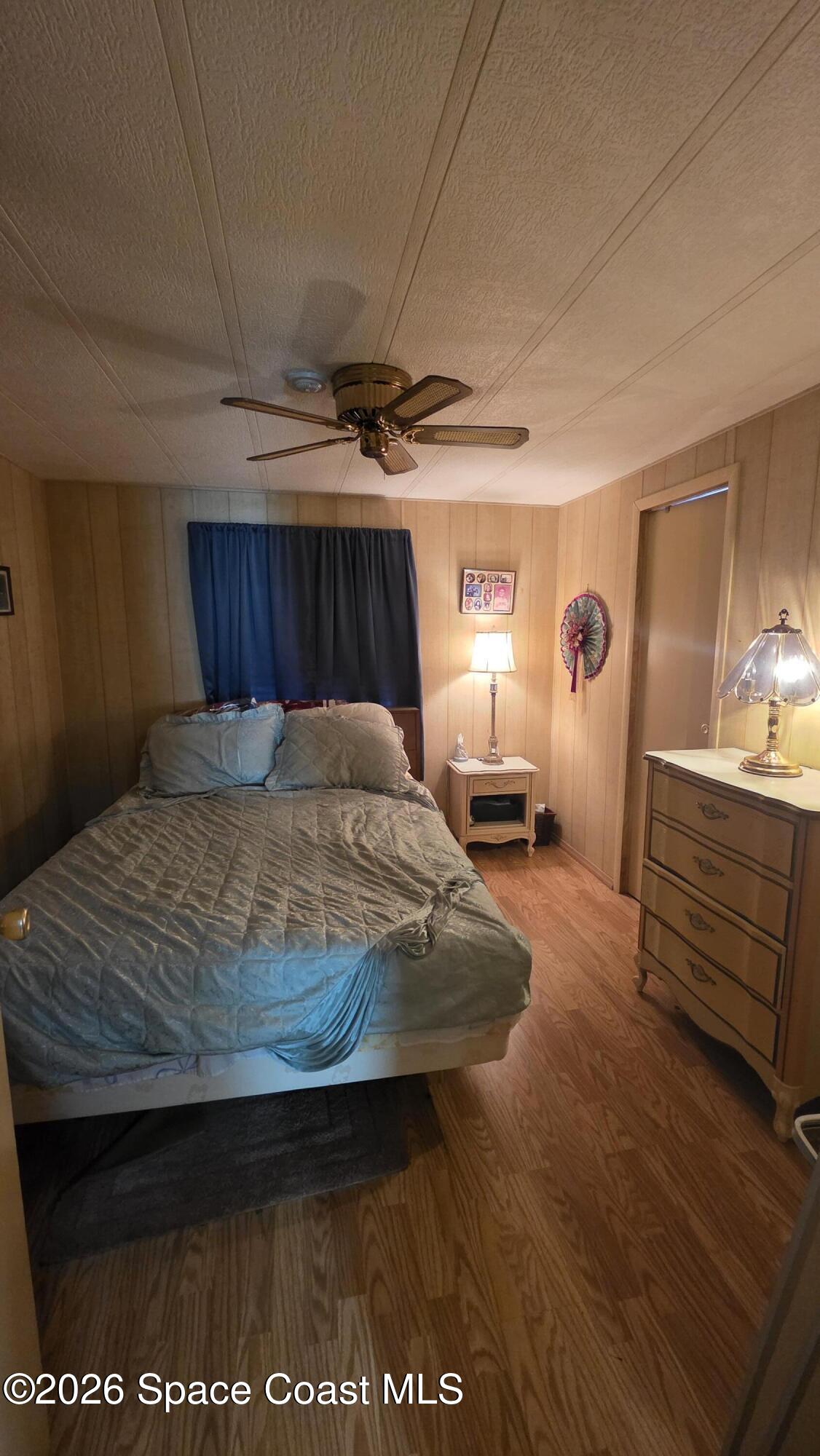 1805 Mango Street Northeast Palm Bay, FL 32905 - Photo 13 of 22 a bedroom with a bed and wooden floor