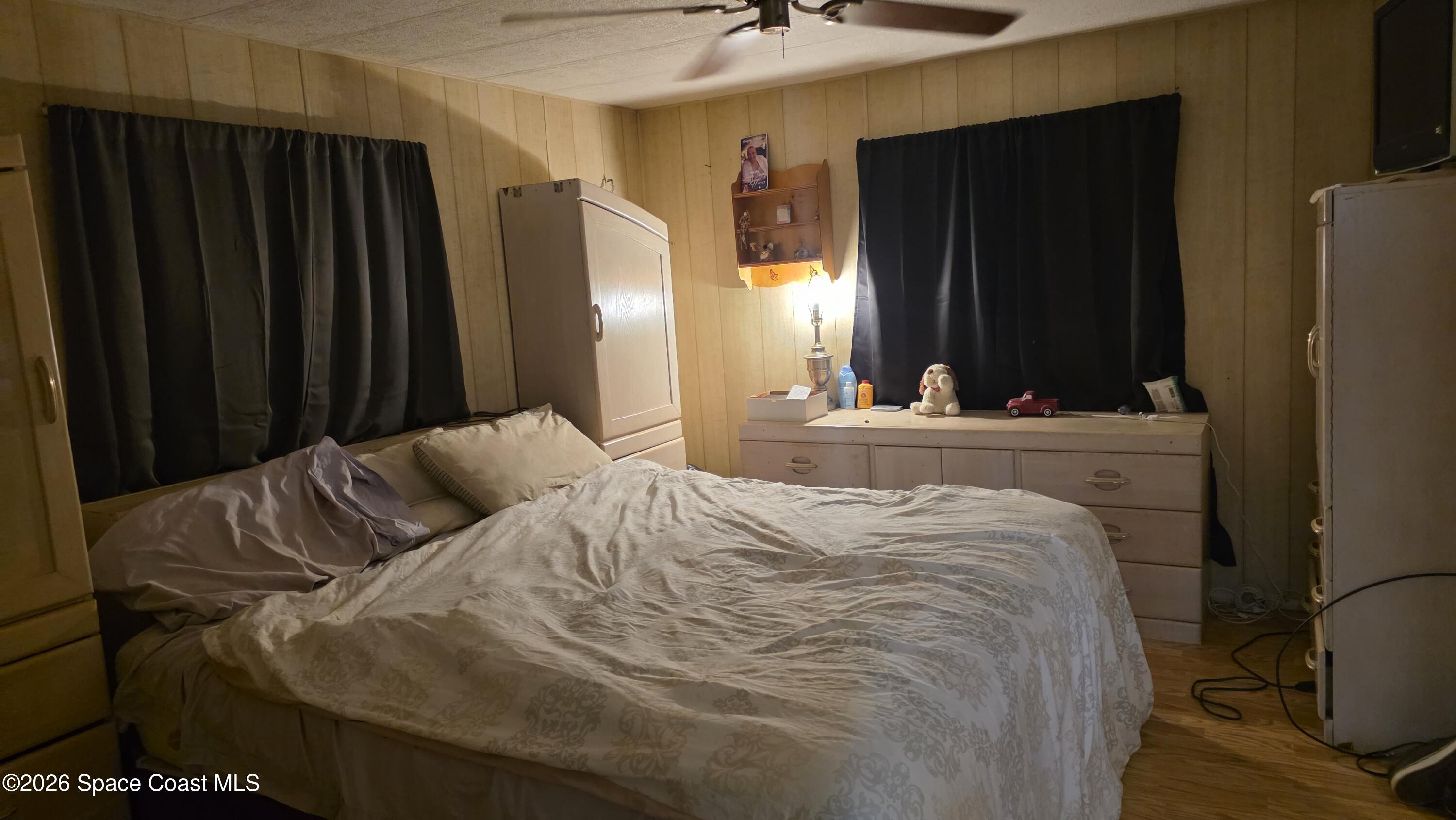 1805 Mango Street Northeast Palm Bay, FL 32905 - Photo 15 of 22 a bedroom with a bed and a mirror