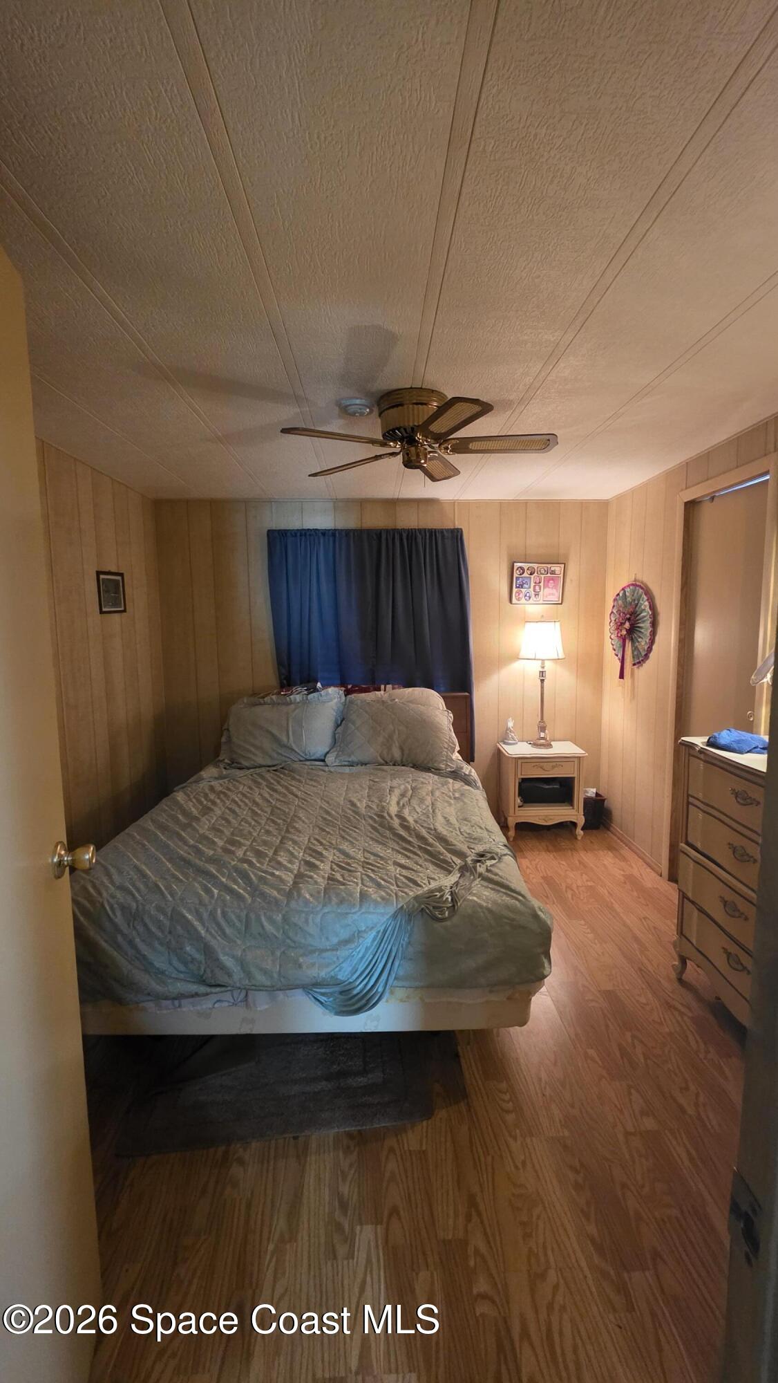 1805 Mango Street Northeast Palm Bay, FL 32905 - Photo 16 of 22 a bedroom with a bed and wooden floor