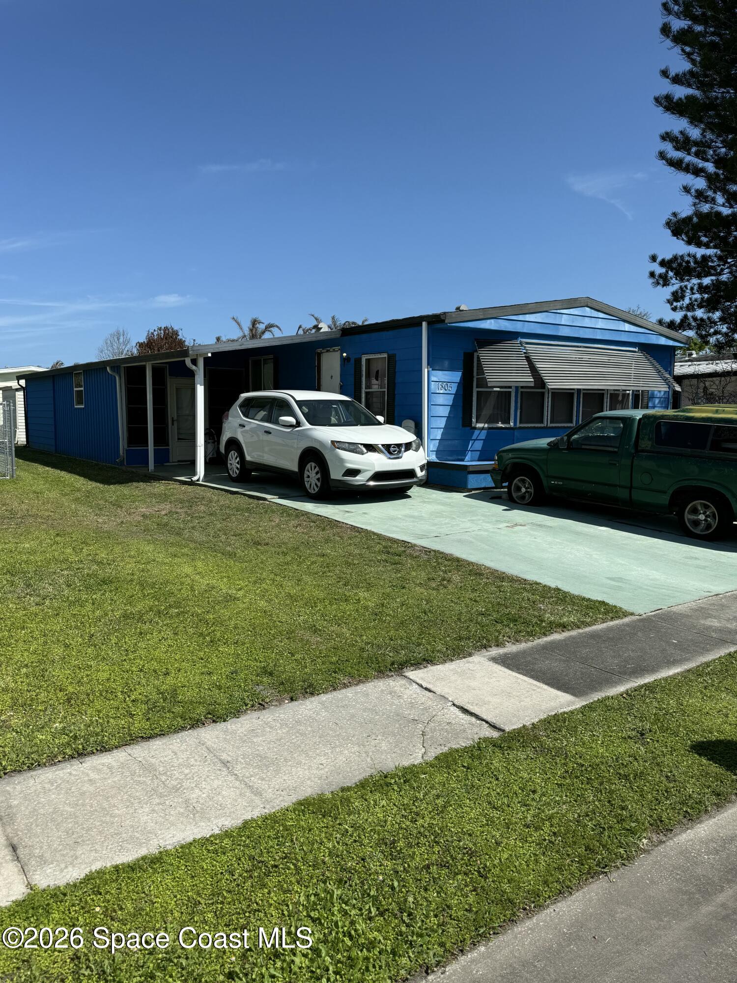 1805 Mango Street Northeast Palm Bay, FL 32905 - Photo 2 of 22 a front view of a house with a garden