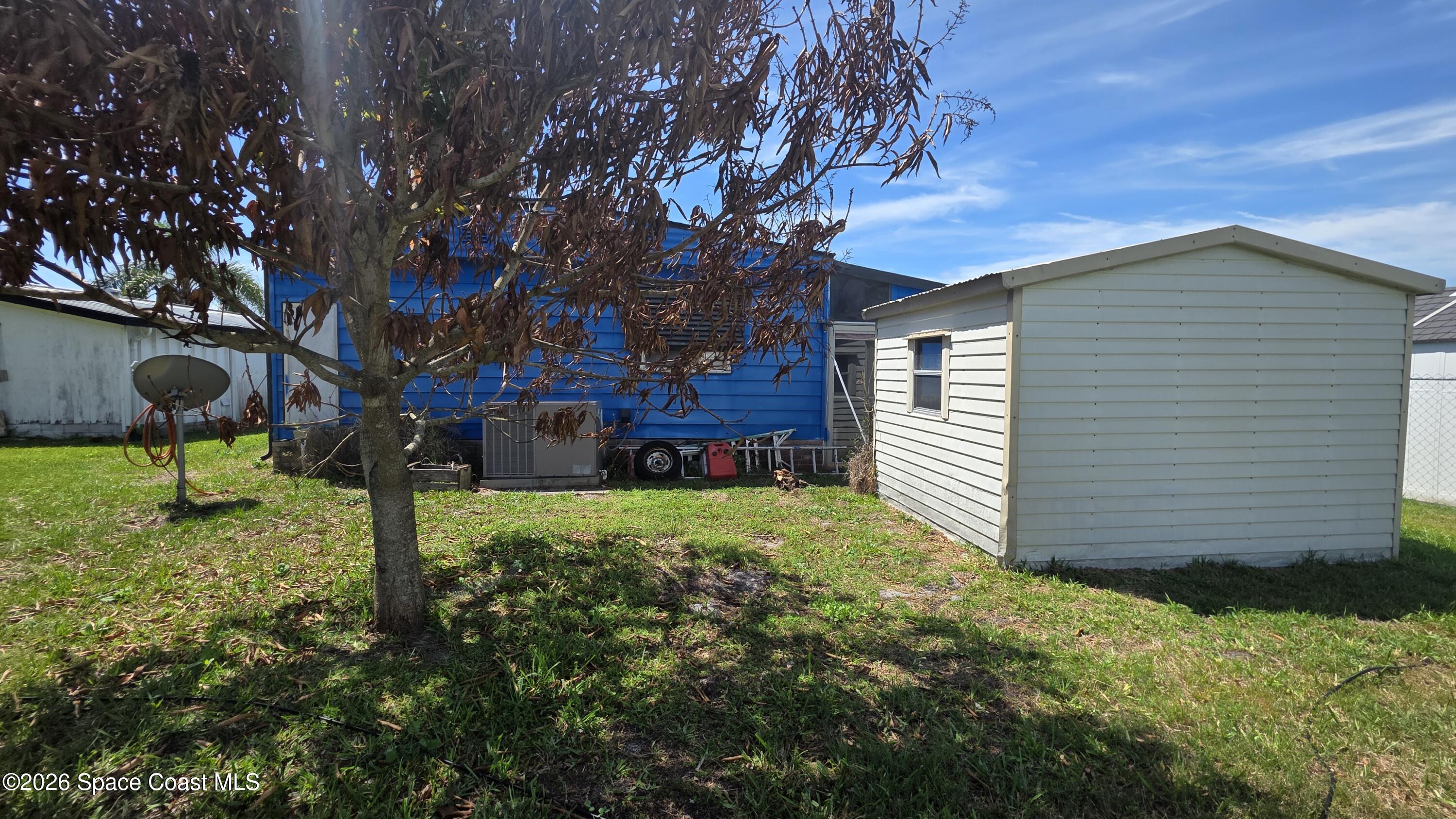 1805 Mango Street Northeast Palm Bay, FL 32905 - Photo 21 of 22 a front view of a house with garden