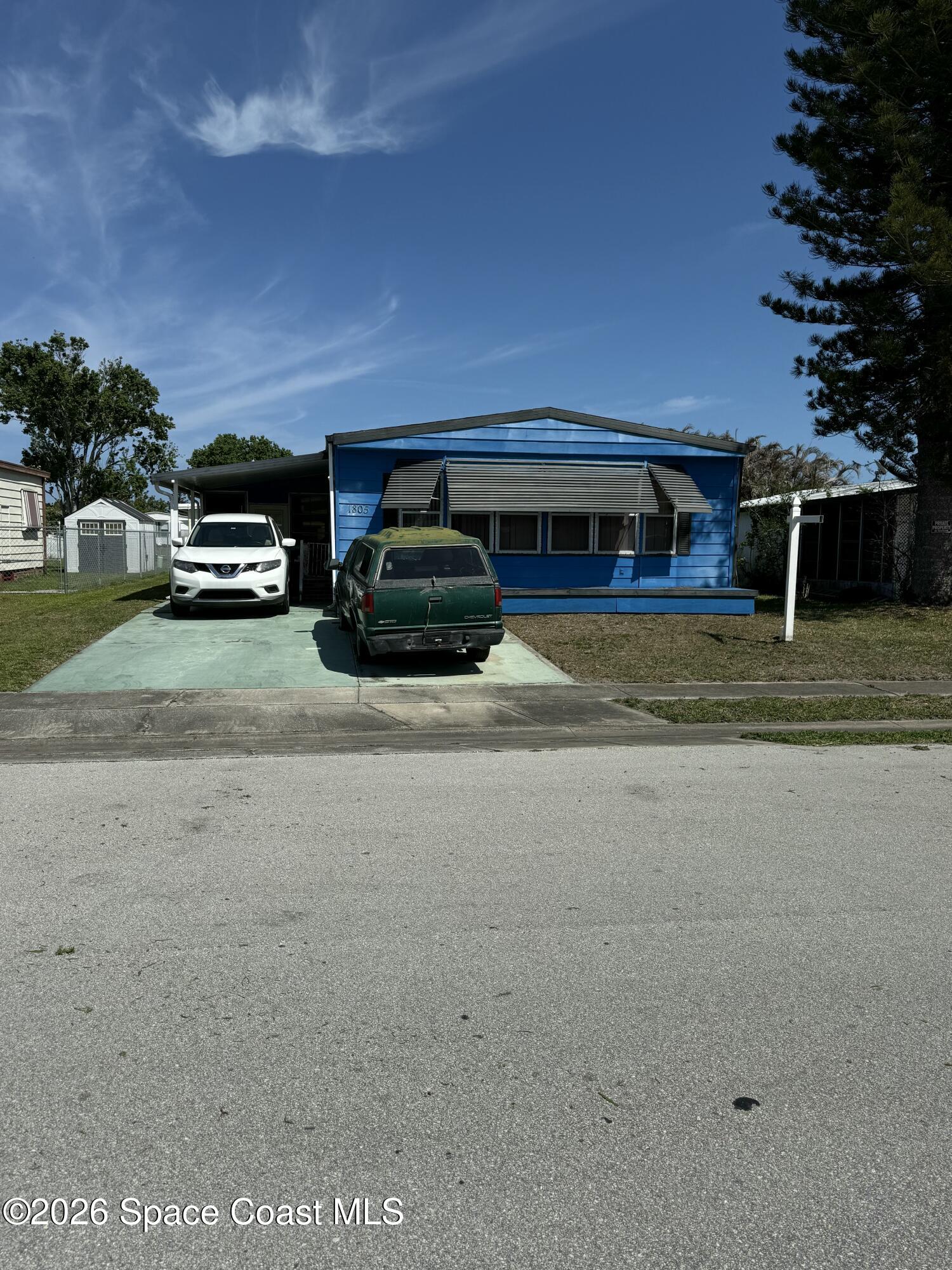 1805 Mango Street Northeast Palm Bay, FL 32905 - Photo 3 of 22 a view of a car parked in front of a house