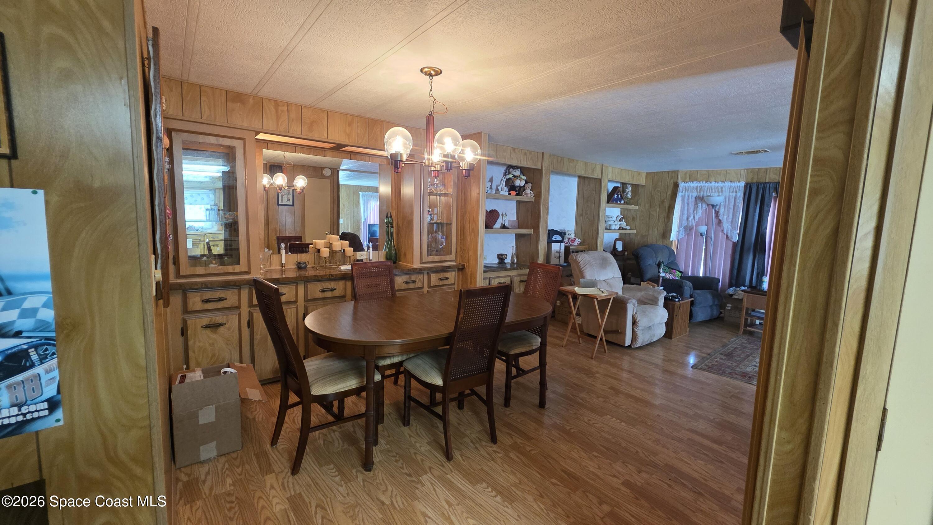 1805 Mango Street Northeast Palm Bay, FL 32905 - Photo 8 of 22 a view of a dining room with furniture and chandelier