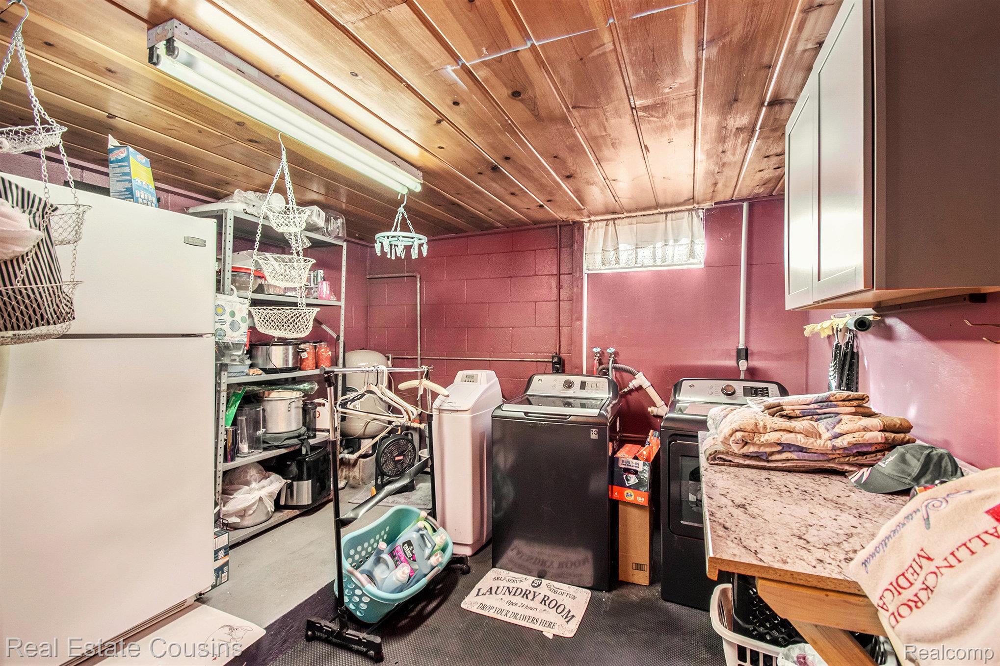 1734 Forest Road Harrison, MI 48625 - Photo 19 of 31 Below grade area featuring freestanding refrigerator, wooden ceiling, and independent washer and dryer