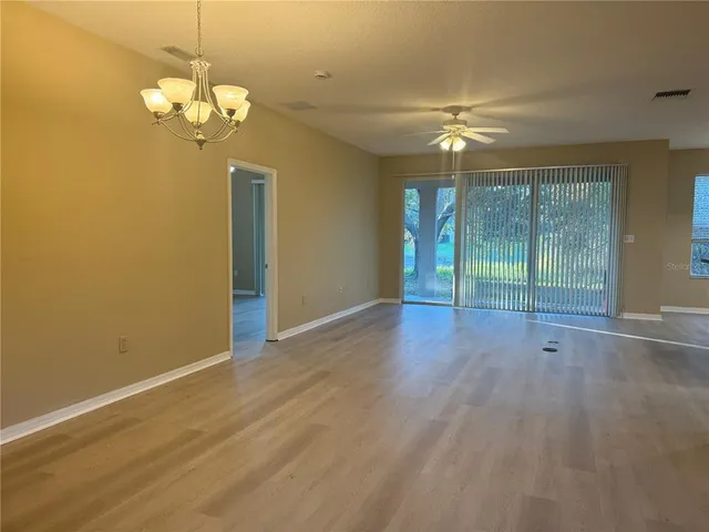 a view of kitchen with stainless steel appliances granite countertop a refrigerator a sink and a stove with wooden floor