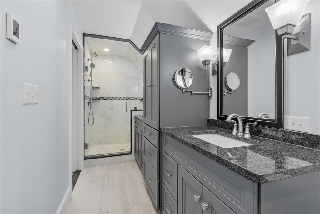 97 Hartwell Road Bedford, MA 01730 - Photo 15 of 42 a bathroom with a granite countertop shower sink and mirror