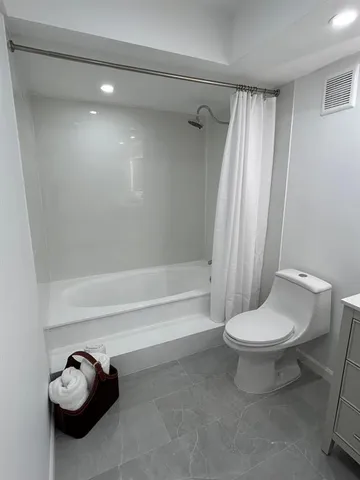 a bathroom with a toilet and a bathtub