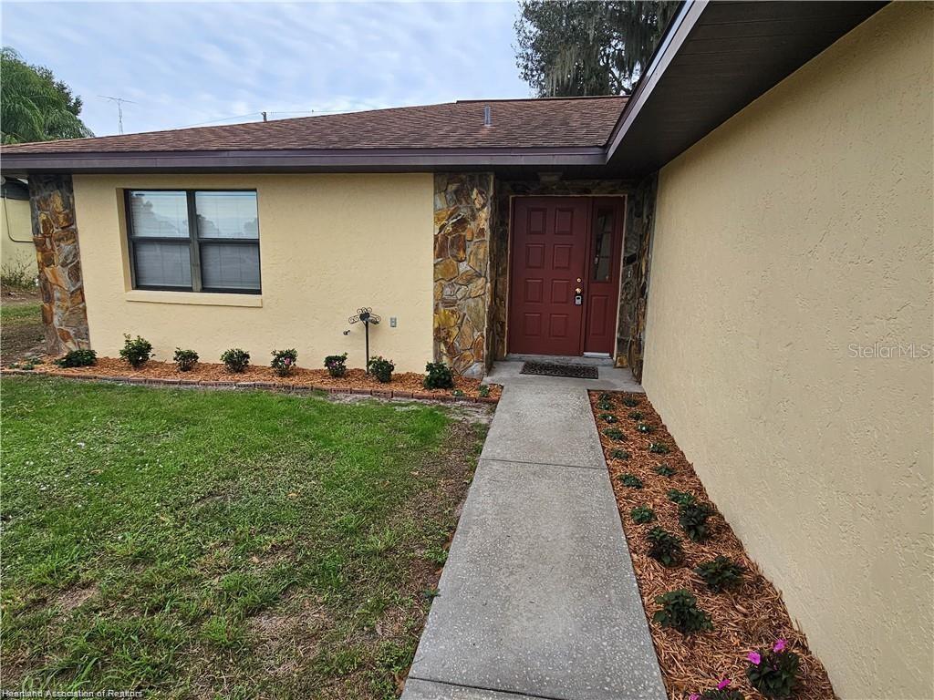 511 Elgin Street Sebring, FL 33875 - Photo 2 of 30 a front view of a house with a yard