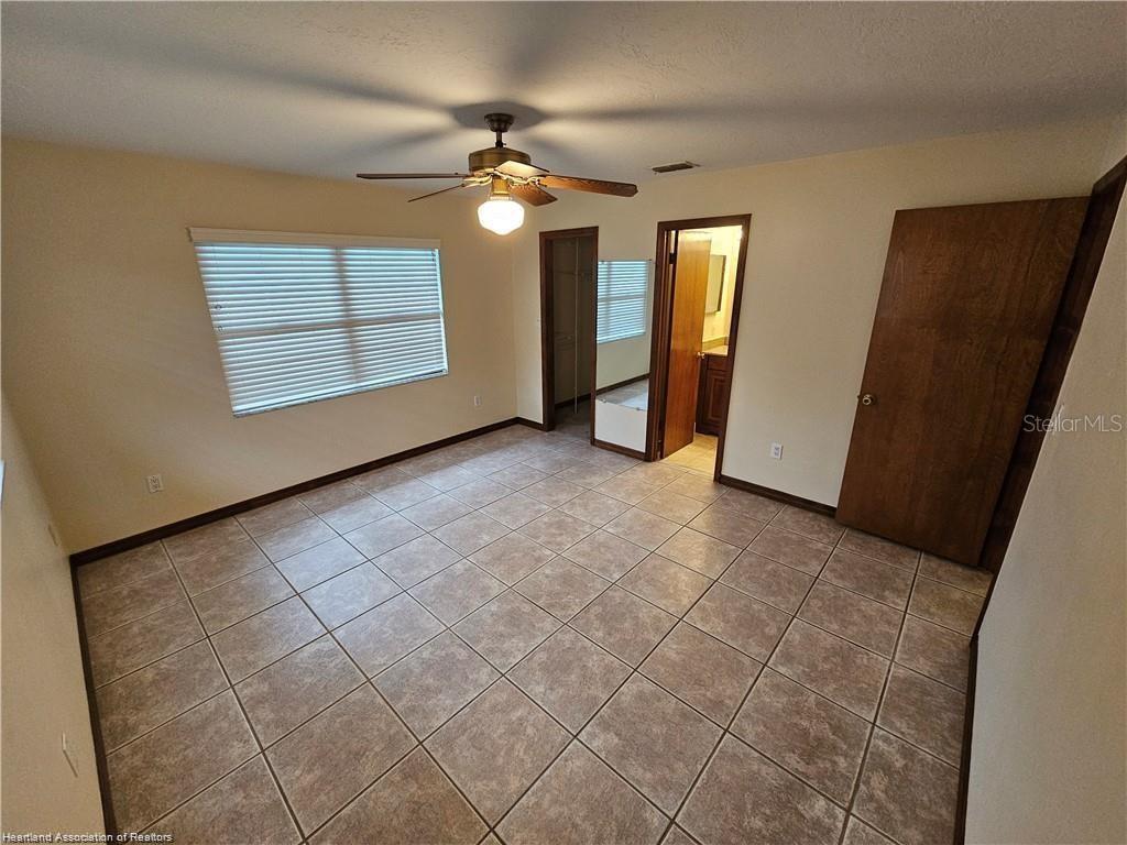 511 Elgin Street Sebring, FL 33875 - Photo 28 of 30 an empty room with windows and fan