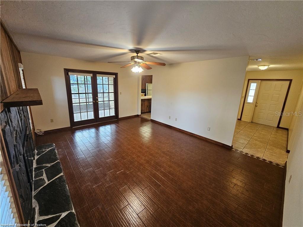 511 Elgin Street Sebring, FL 33875 - Photo 29 of 30 an empty room with wooden floor fan and windows