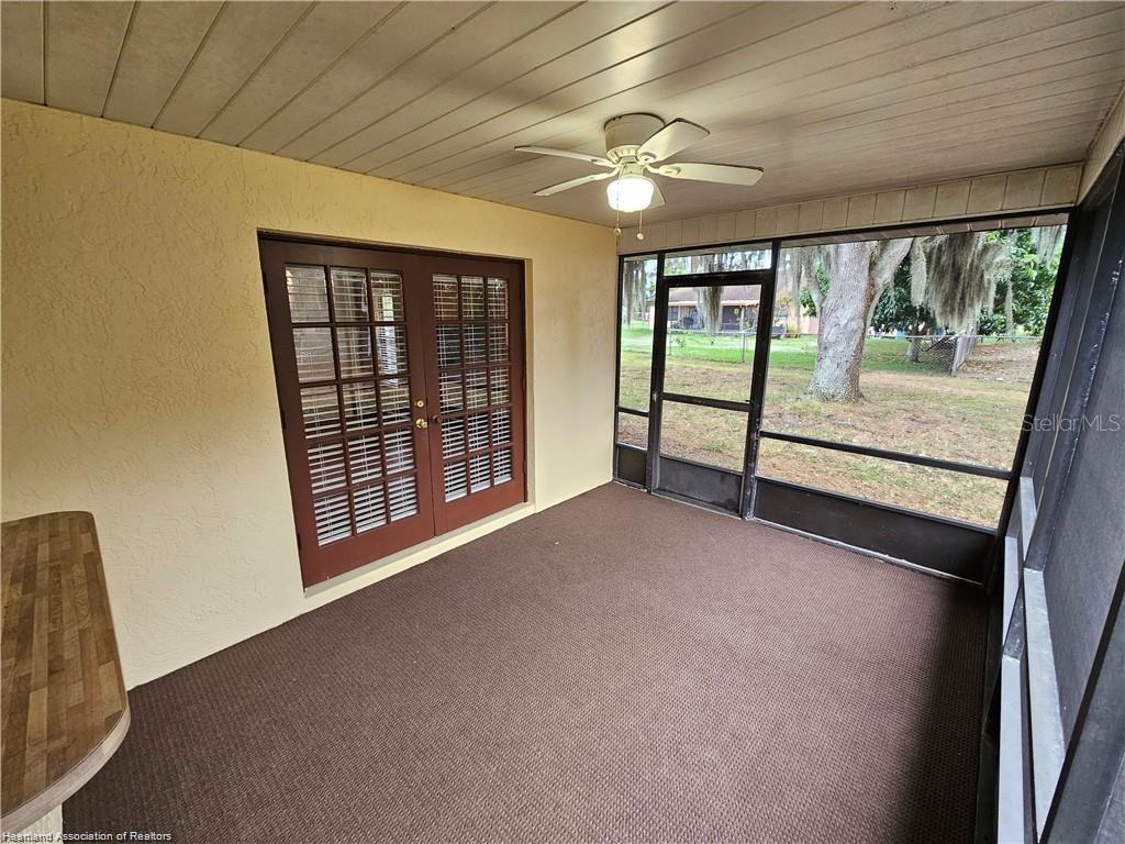 511 Elgin Street Sebring, FL 33875 - Photo 6 of 30 wooden floor and windows in an empty room