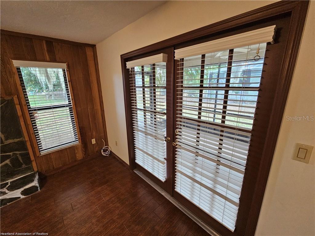 511 Elgin Street Sebring, FL 33875 - Photo 7 of 30 a view of a room with wooden floor and windows